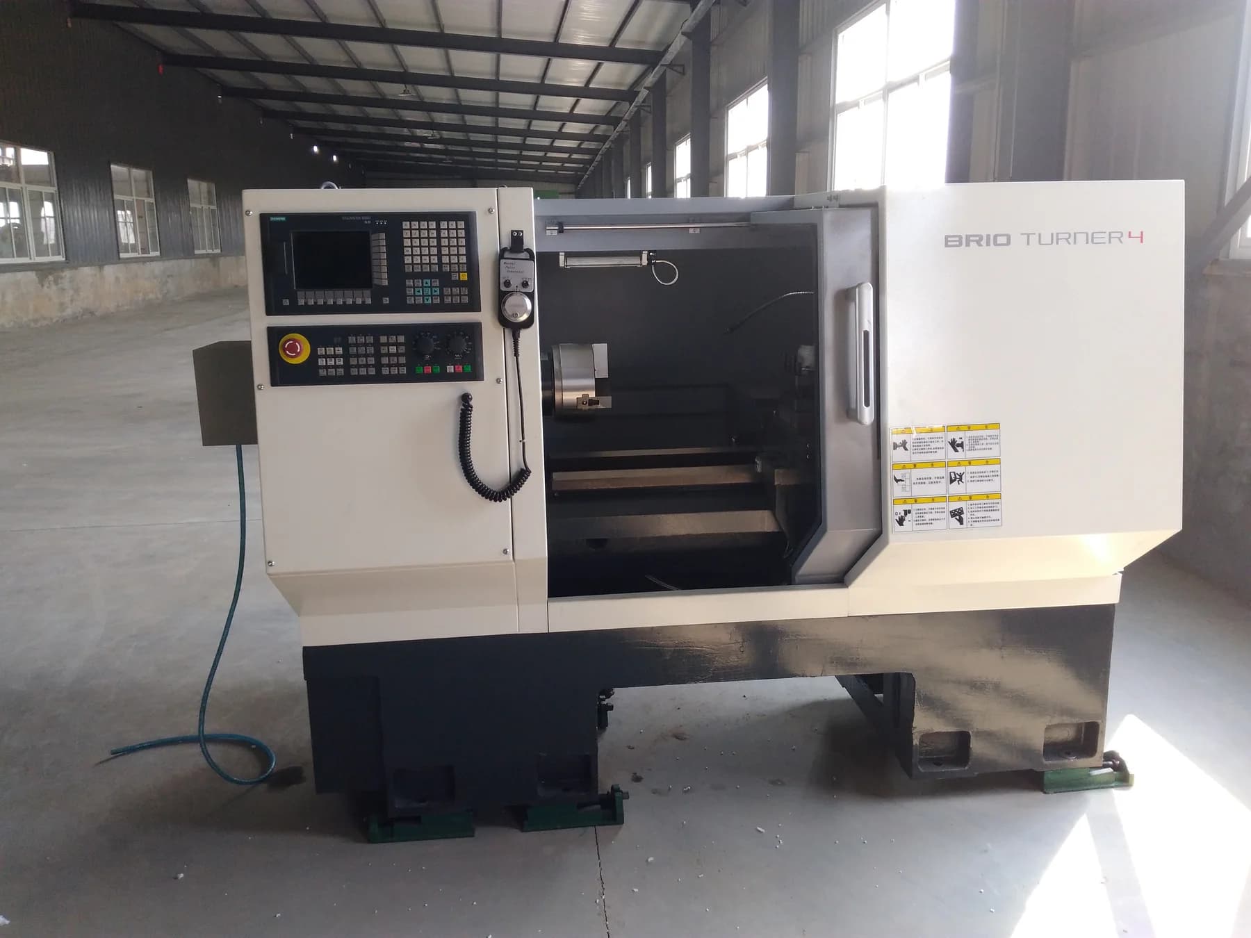 Enclosed CNC turning equipment inside a factory workshop