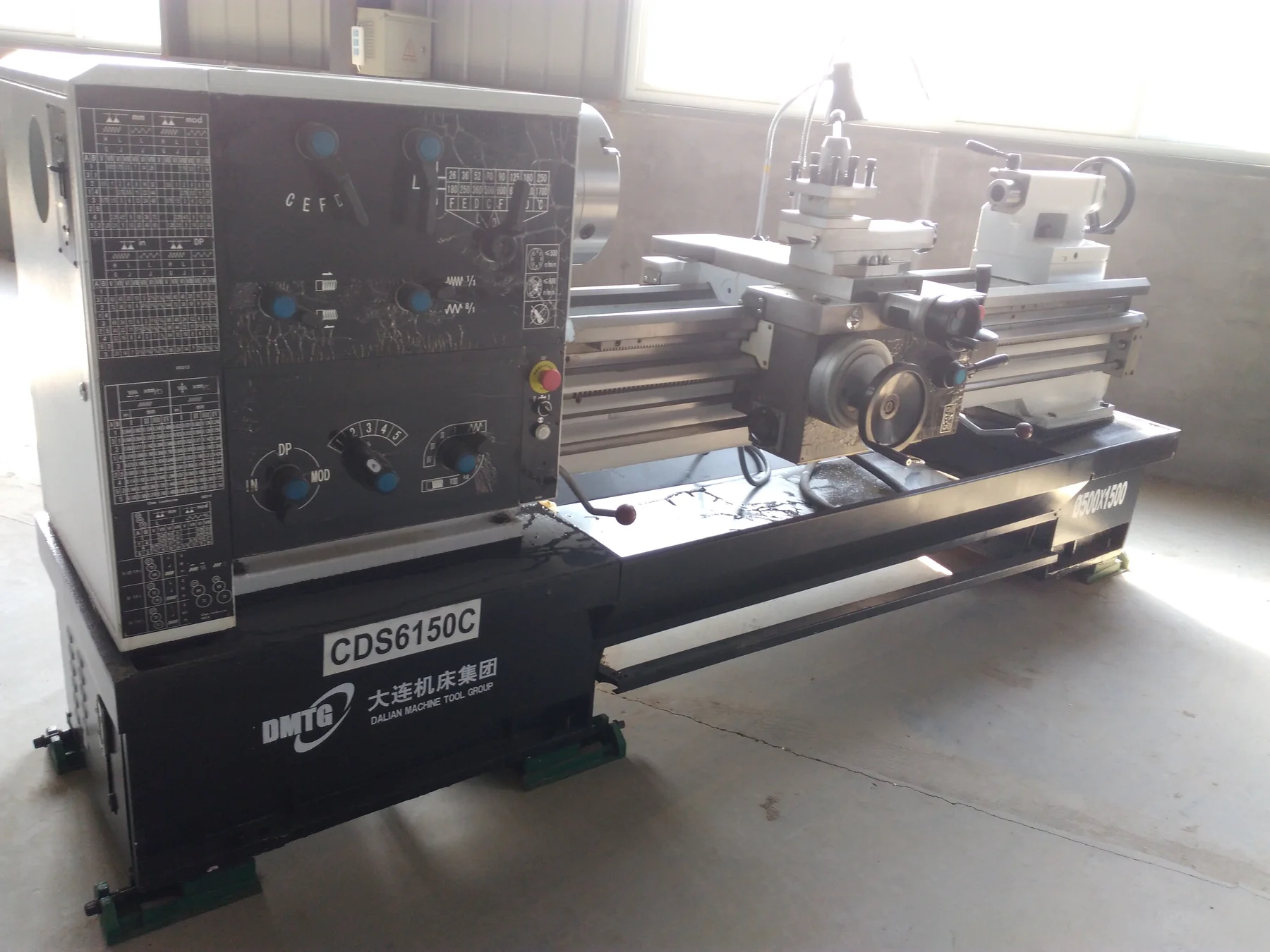 Close view of a metalworking lathe control panel and working area