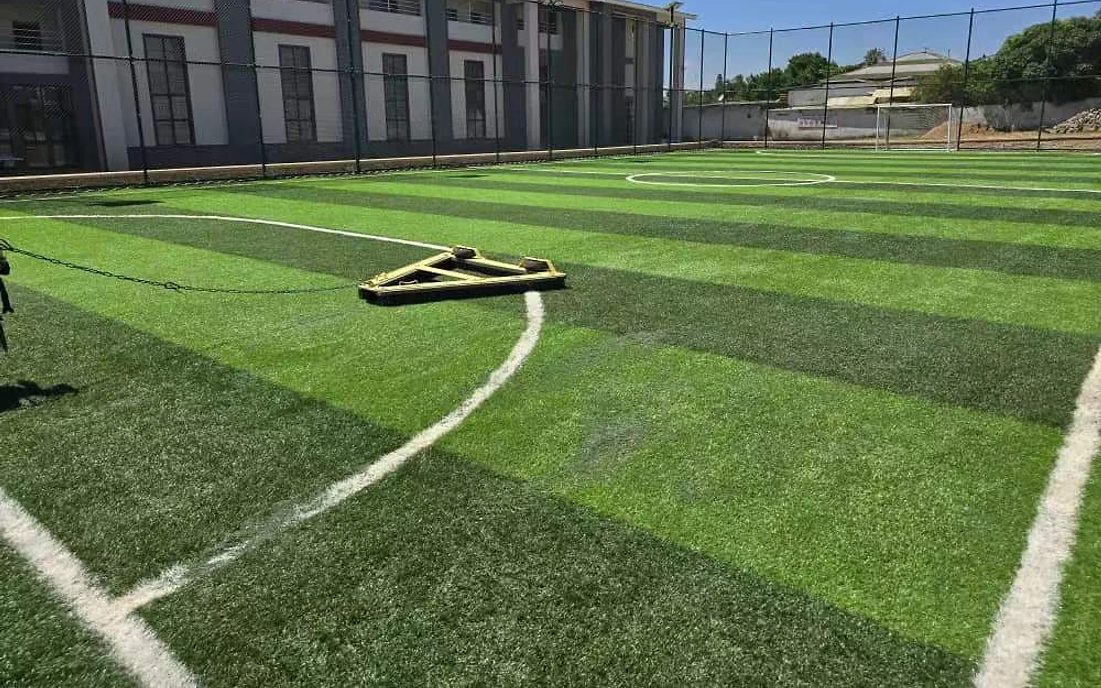 Artificial-turf maintenance equipment on the completed Malawi football pitch